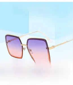 Detail of square gold metal frame sunglasses with purple orange gradient lenses