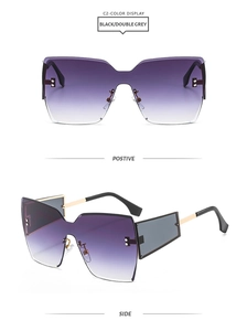 Close-up of rimless gradient purple lenses with metal rivets and golden temples