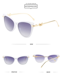 Detailed view of white cat-eye sunglasses with purple gradient lenses and gold metal butterfly