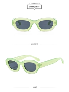 Detail view of stylish green translucent retro sunglasses with wide temples and grey lenses