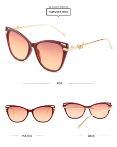 Detail of red cat-eye sunglasses with gold butterfly hinges and gradient lenses