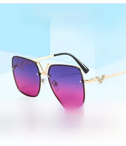 Detail of square gold metal sunglasses with purple gradient lenses and crystal V-hinge