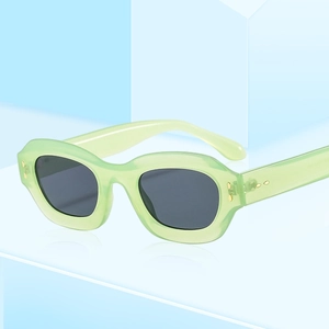 Fashionable semi-transparent green sunglasses with grey lenses on blue geometric stands