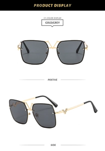 Detail view of square metal sunglasses with V-shaped diamond accents on frame and temple