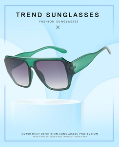 Detail of square oversized green sunglasses with UV400 gradient lenses and thick frame