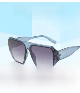 Detail view of oversized square sunglasses with blue frame and purple gradient lenses
