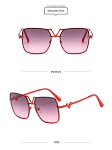 Detail of red square metal sunglasses with crystal-studded V logo on temples