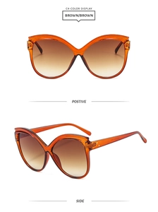 Détails de lunettes de soleil papillon œil de chat avec monture ambre et verres dégradés