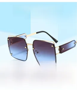 Detail of square oversized sunglasses with blue gradient lenses and gold metal frames
