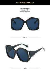 Detail view of large irregular black frame sunglasses with hollow temple design