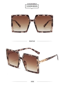 Detail of square oversized tortoise sunglasses with gold chain temples and gradient lenses