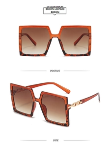 Detail view of brown leopard square sunglasses with golden chain accents and gradient lenses