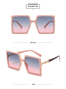 Detail of pink gradient square sunglasses featuring decorative gold metal chain hinges