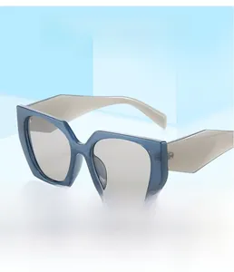 Modern polygonal sunglasses with navy blue frames and grey temples on blue background