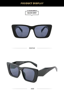 Detail view of black square cat-eye sunglasses with geometric temples and grey lenses
