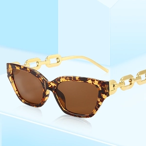 Fashionable leopard print square sunglasses with bold gold chain temples and brown lenses