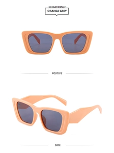 Detail view of vintage orange cat-eye sunglasses with grey lenses from front and side