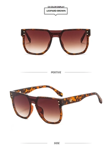 Detail view of retro square leopard print sunglasses with brown gradient lenses and gold trim