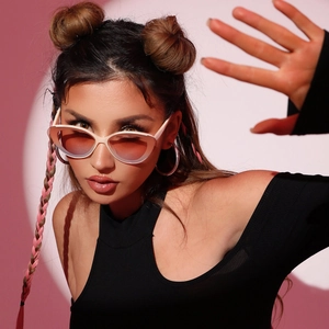 Fashionable white cat-eye semi-rimless sunglasses with gradient pink lenses on a model