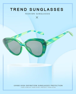 Detail of green cat-eye sunglasses with UV400 protection and striped temples