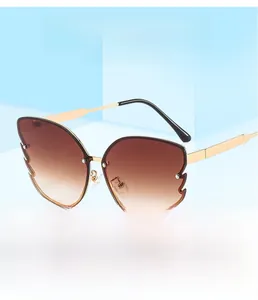 Detail of butterfly metal sunglasses with gradient brown lenses and wavy edge cut