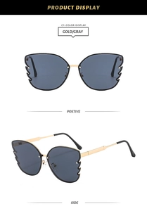 Detailed view of butterfly-shaped gold metal sunglasses with gray lenses from two angles