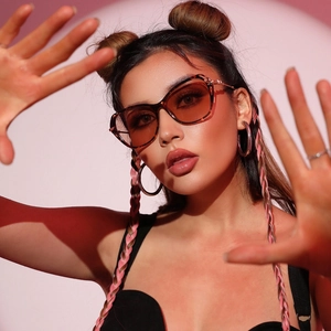 Vintage cat-eye sunglasses with tortoise shell frames and gradient lenses on a model