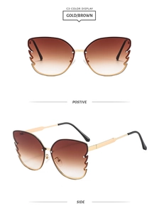 Detail view of gold butterfly frame sunglasses with brown gradient wing-cut lenses