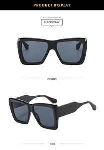Detail view of bold square black frames with dark gray lenses and wide temples