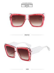 Detail view of transparent red rectangular frame sunglasses with brown gradient lenses