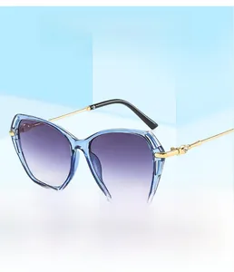 Detail of gradient purple lenses and gold metal temples on vintage cat eye sunglasses