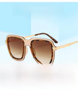 Detail of square sunglasses with tortoiseshell frames and sleek gold metal temples
