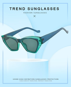 Detail of teal geometric sunglasses with UV400 protection on a modern display stand