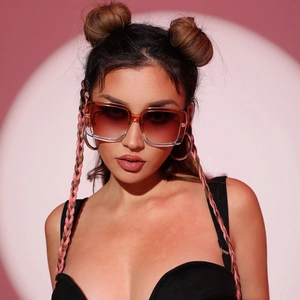 Fashionable oversized square sunglasses with amber gradient lenses on a stylish model