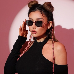 Fashionable square tortoise shell sunglasses with dark grey lenses on model