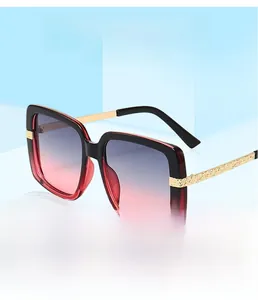 Detail of square oversized sunglasses with gradient lenses and ornate metal temples