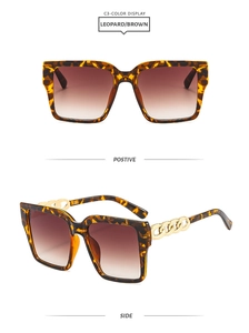 Detail of square leopard sunglasses with gold chain temples and brown gradient lenses