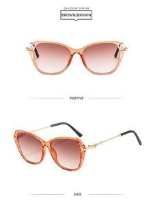 Detail view of cat eye sunglasses with brown gradient lenses and gold rhinestone temples