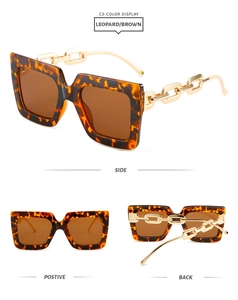 Detail view of leopard print square sunglasses featuring gold chain-link temple accents