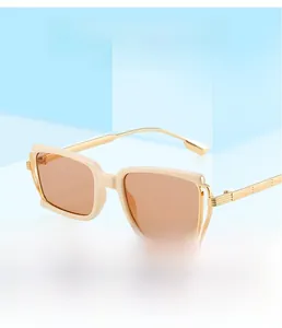 Detailed view of cream square frame sunglasses with engraved gold metal temples