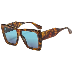 Retro square oversized tortoiseshell sunglasses with vibrant blue lenses shown at an angle