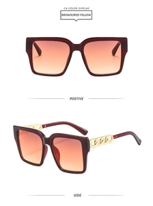 Detail view of burgundy square sunglasses with orange gradient lenses and gold chain arms