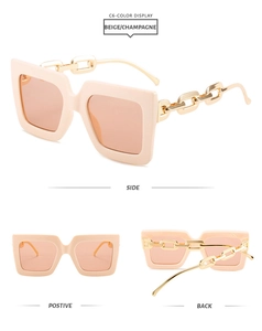 Detail view of beige square sunglasses featuring stylish gold chain-link temples