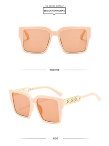 Detail of square sunglasses in beige with orange lenses and golden chain arms