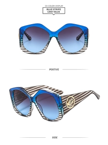 Vue détaillée des grandes lunettes de soleil polygone avec monture rayée bleue et or