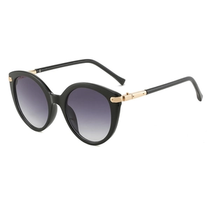 Occhiali da sole cat-eye rotondi neri da donna con lenti sfumate e aste in metallo dorato
