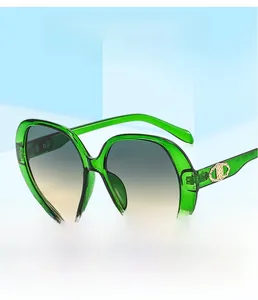 Close-up of green square frame sunglasses with golden CD metal logo on the temple