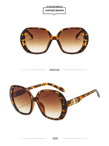 Detail of leopard brown sunglasses with golden metal hinges and gradient brown lenses