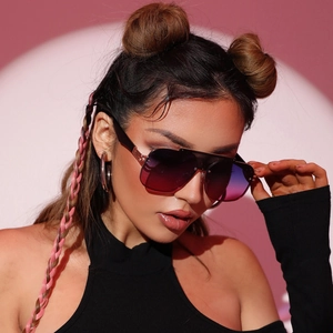 Fashionable oversized aviator sunglasses with gradient lenses and black frames on a model