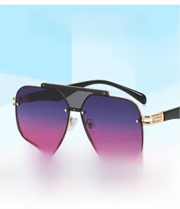 Detail of oversized sunglasses with purple gradient lenses and gold metal cutout hinges